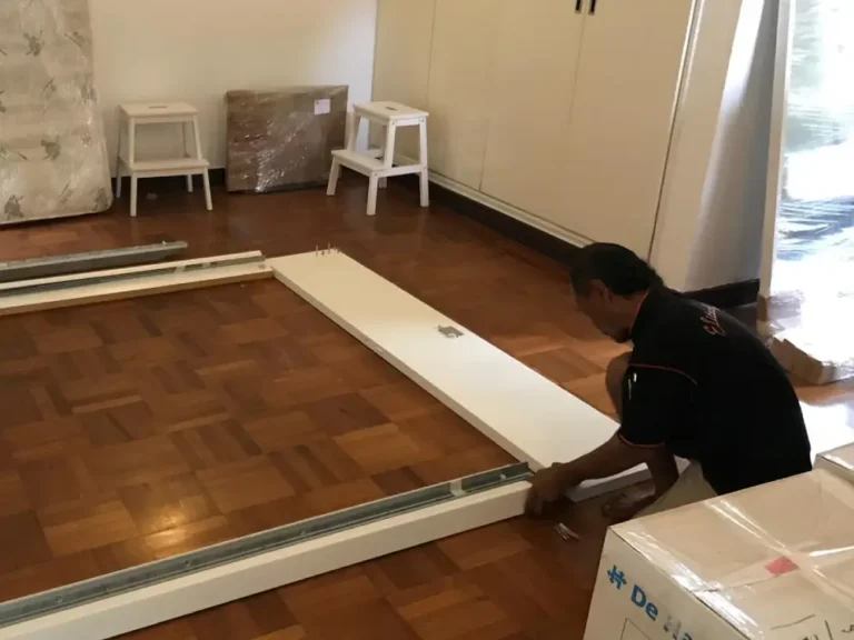 Elite Movers team member reassembling customers' bed frame